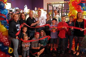 Executive Director Melissa Cerasuolo (far right) assists owner Steve Belmonte (third from left) in a ribbon cutting ceremony for the new game room. 
